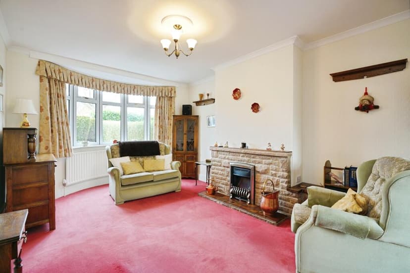Dated living room before transformation with neutral beige walls and classic furniture arrangement